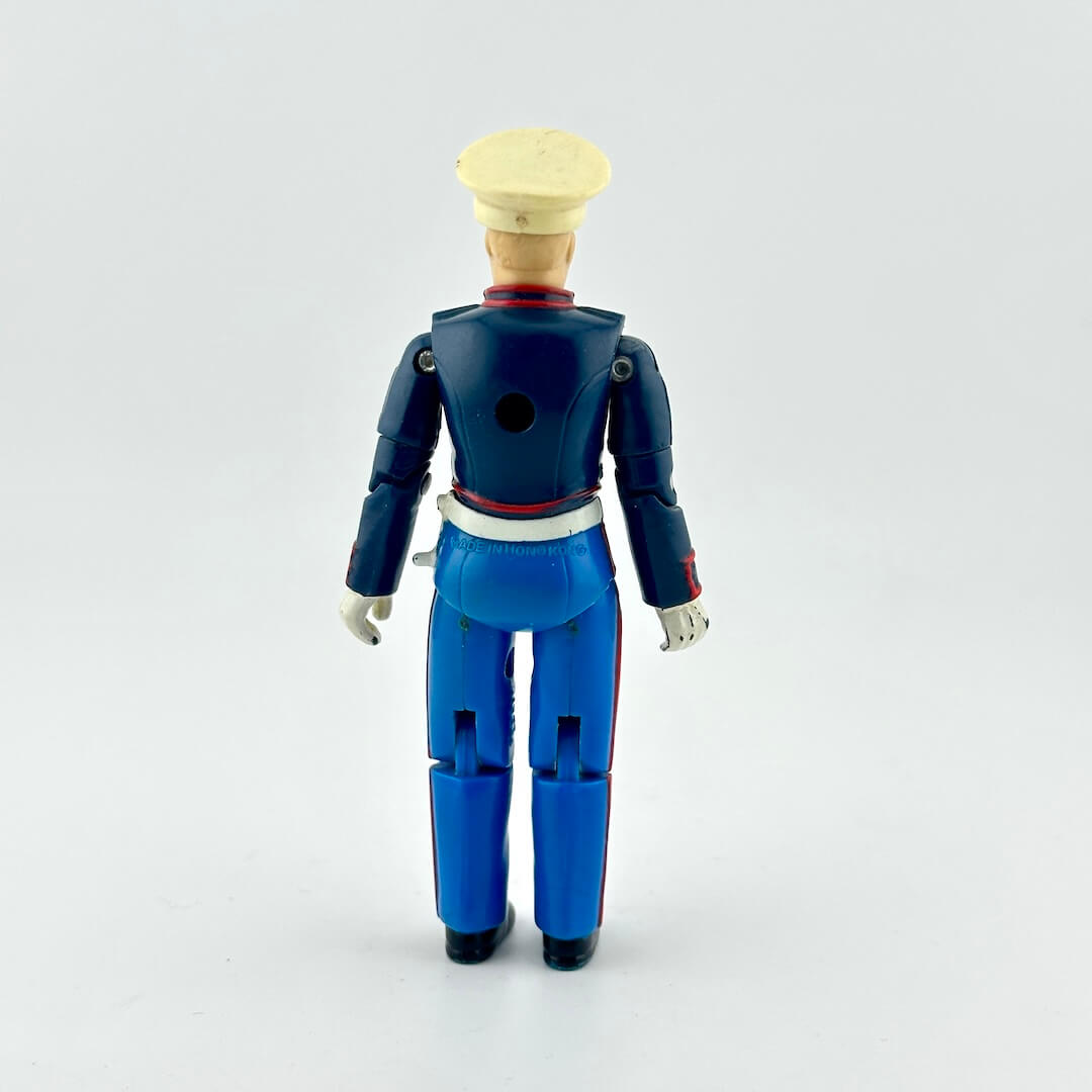 GI Joe action figure in military dress uniform, photographed on white background. 