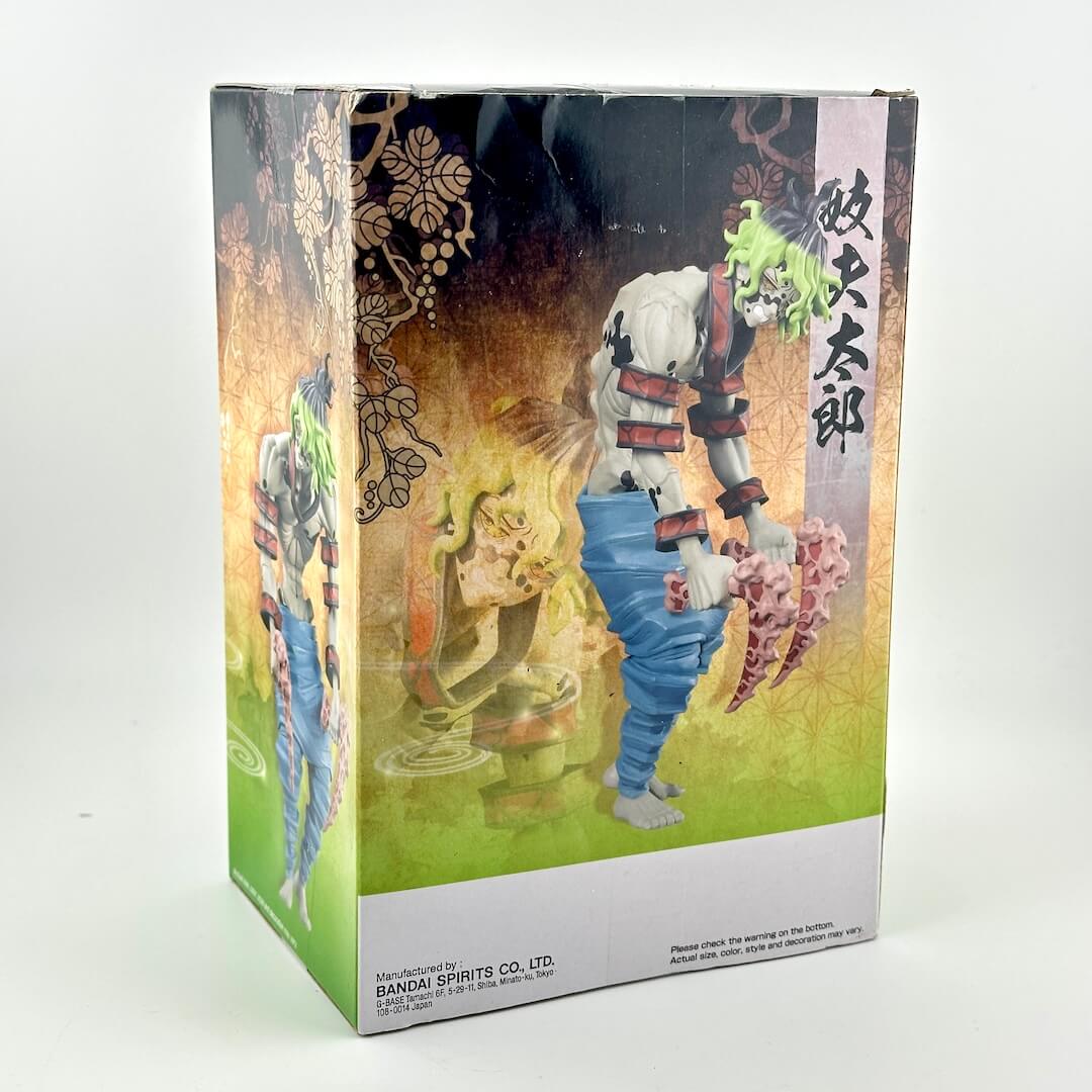 A boxed collectible figure from an anime package, photographed on a plain light background. 