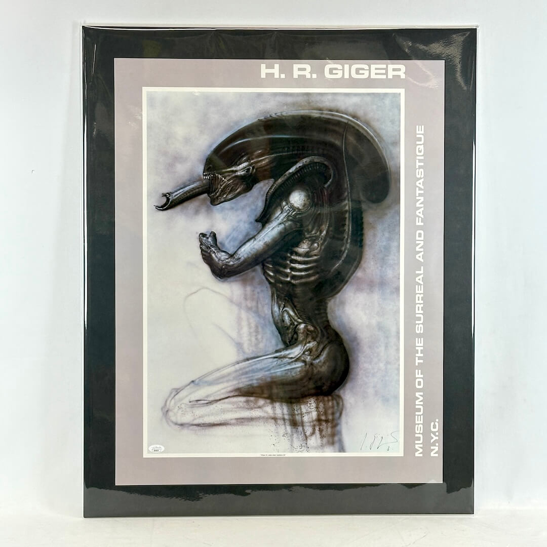Matted artwork of a creature design by H.R. Giger with a black border and white background.