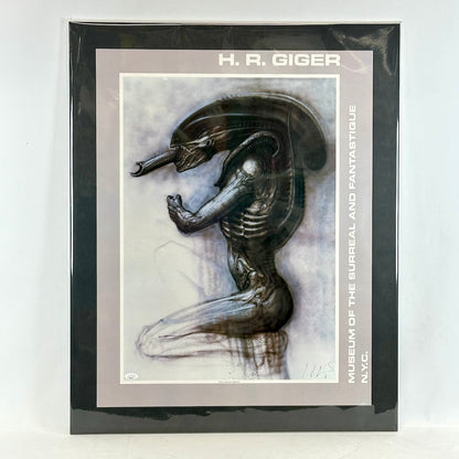 Matted artwork of a creature design by H.R. Giger with a black border and white background.