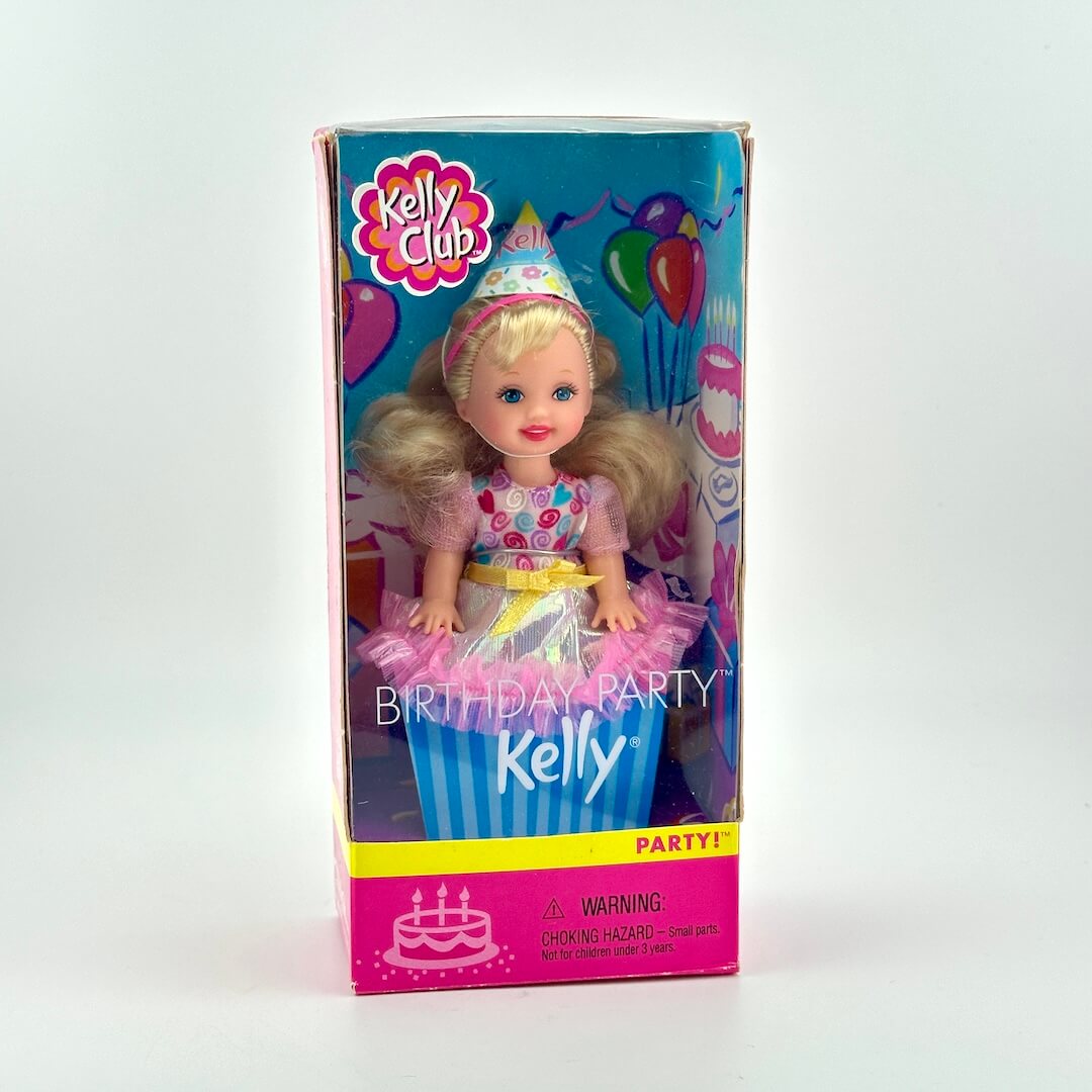 Boxed Kelly doll from the Kelly Club with birthday theme on a white background