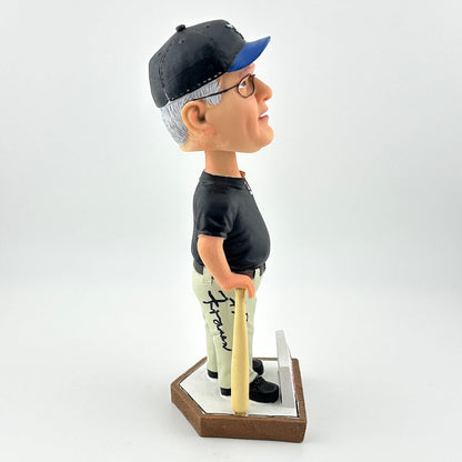 Bobblehead figure of a person wearing a black cap and glasses, holding a baseball bat on a white background