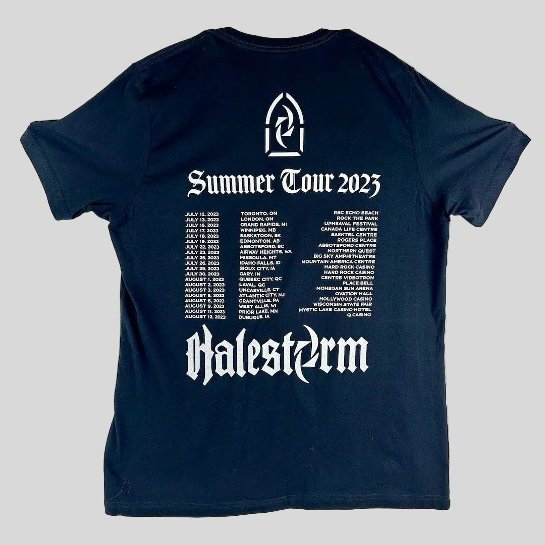 A black short-sleeve t-shirt laid flat, featuring a tour schedule and the text 'Summer Tour 2023' and 'Halestorm'.