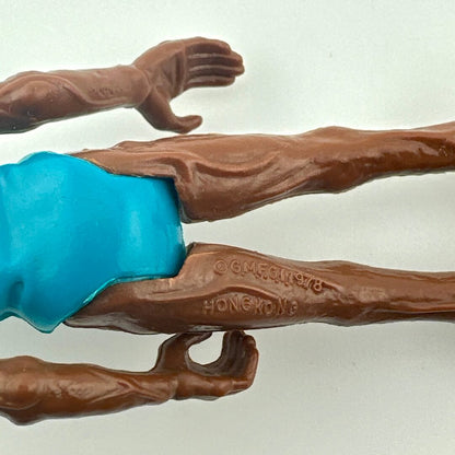 Toy figure with brown arms and legs holding a blue object on a white background