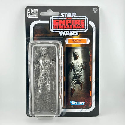 Star Wars action figure in its original blister packaging with retro-style card back; figure is Han trapped in carbonite.