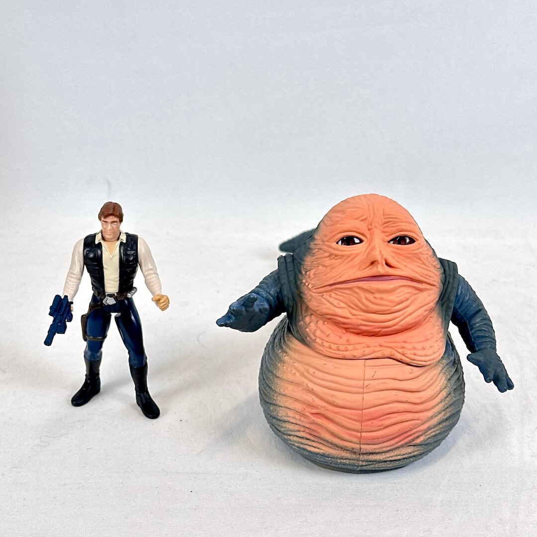 Two action figures, one resembling a character from a science fiction franchise, on a white background.