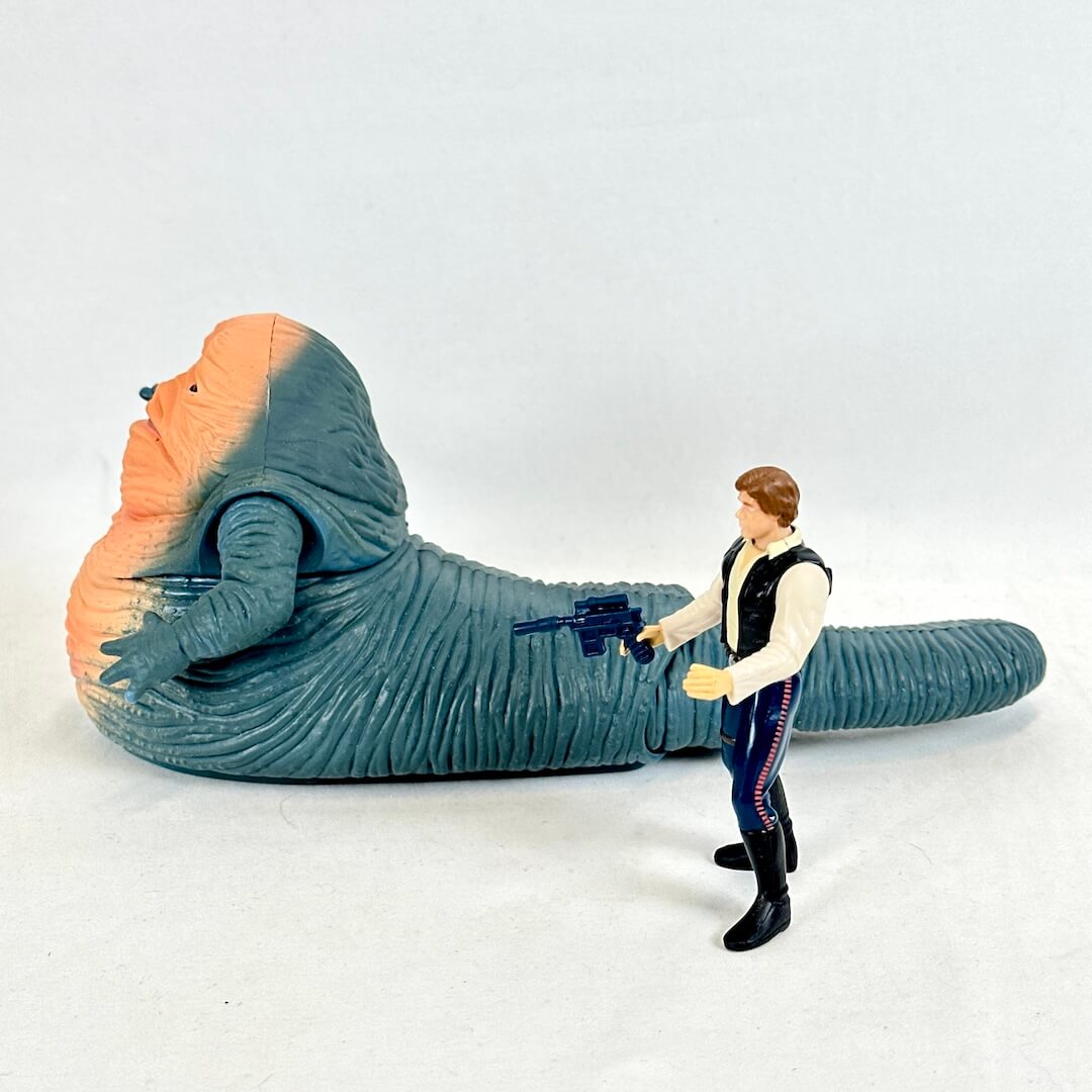 Toy figure of a character with a large creature on a white background