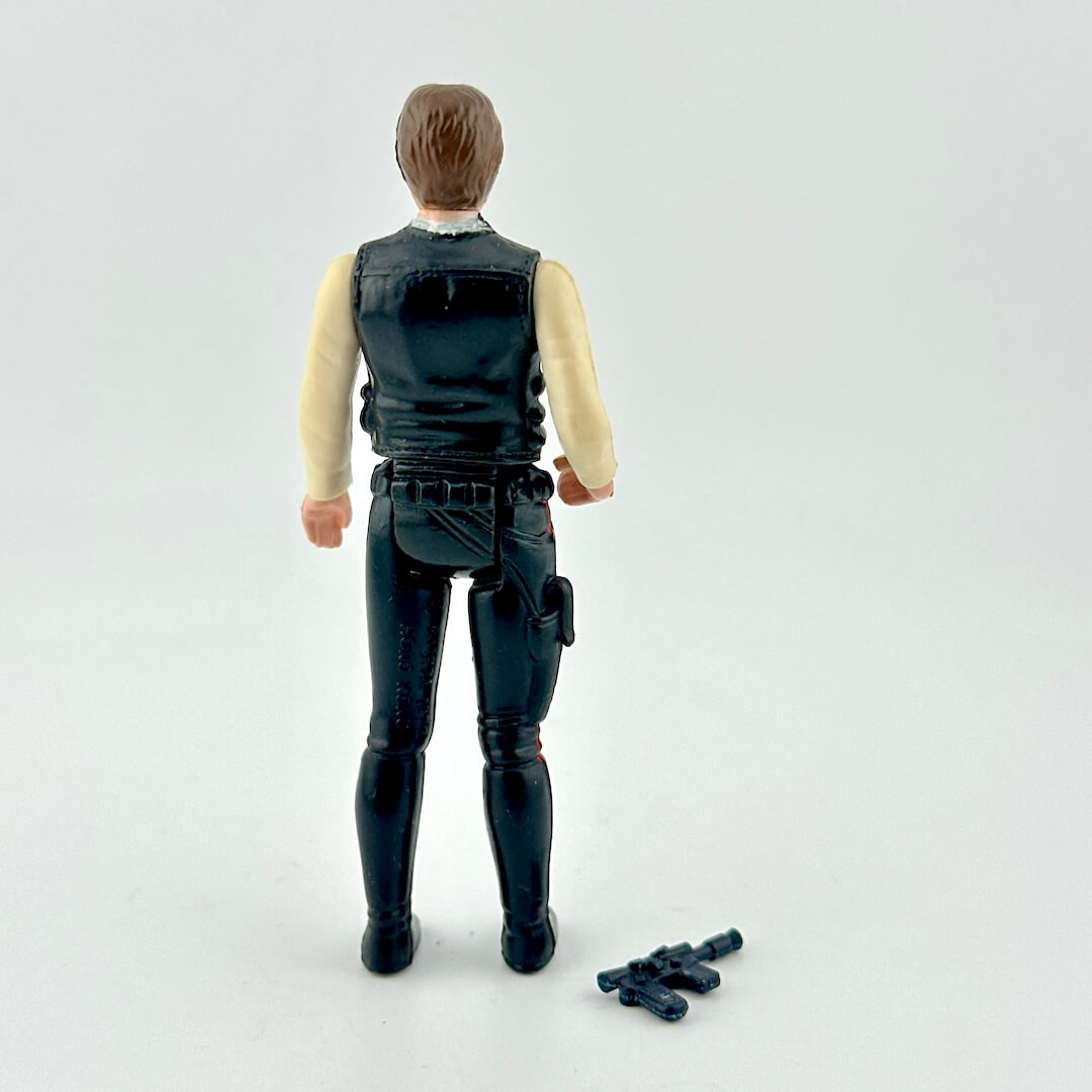 Action figure in a black vest and pants with a white background