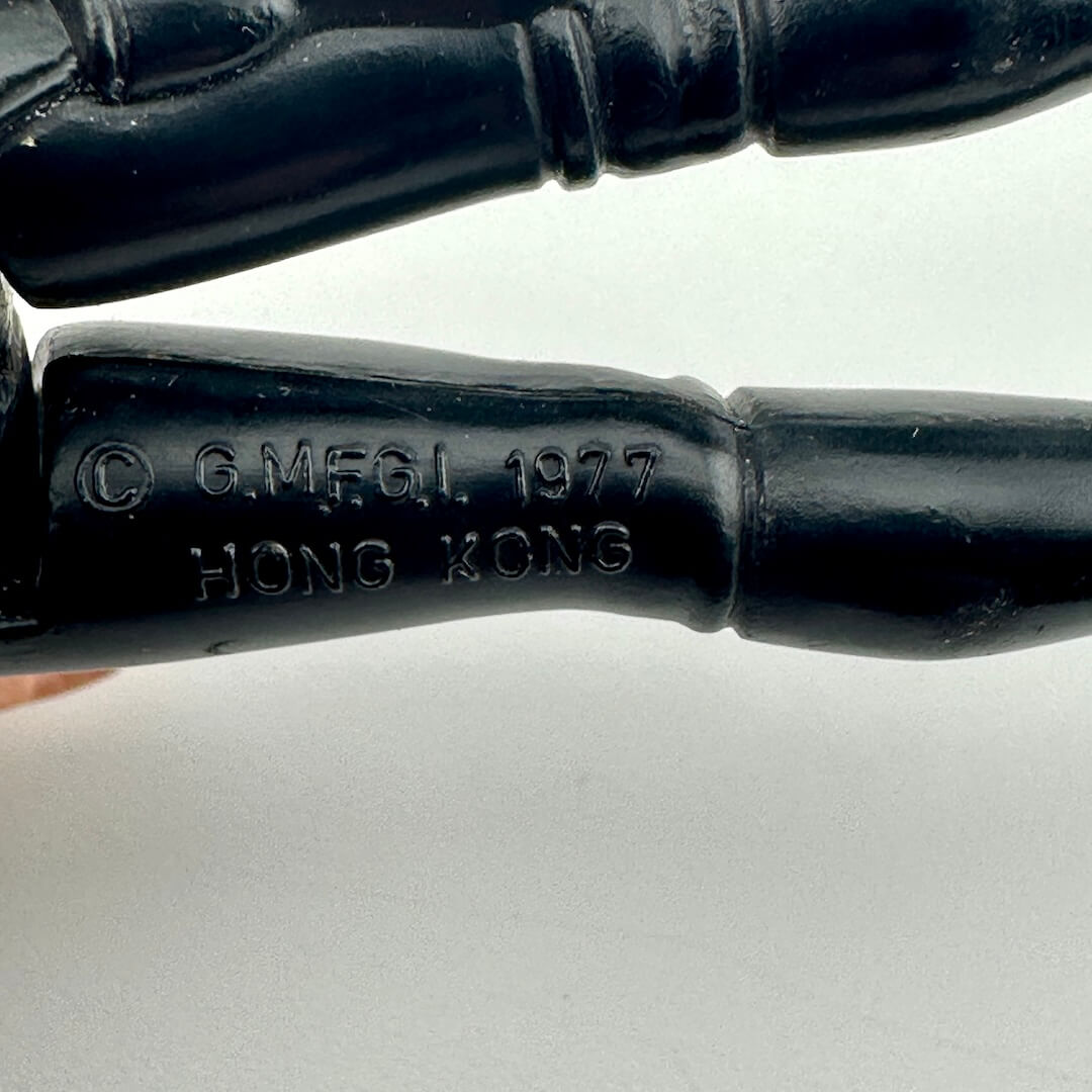 Close-up of back of figure's legs to show COO and copyright information. 