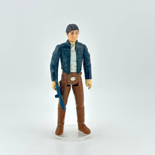 Action figure in a blue jacket and brown pants holding a weapon on a white background