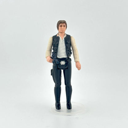 White male action figure in a white shirt, navy vest and pants on a white background