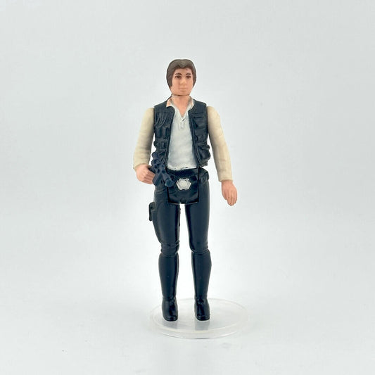 White male action figure in a white shirt, navy vest and pants on a white background