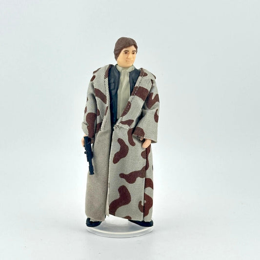 Action figure wearing a long coat with camouflage pattern on a white background