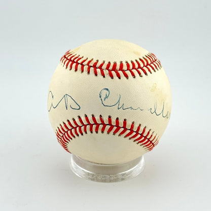 Baseball with autographs on a clear stand against a white background