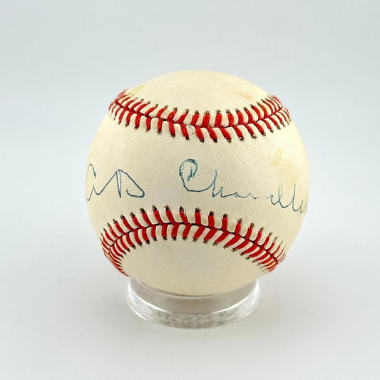 Baseball with autographs on a clear stand against a white background