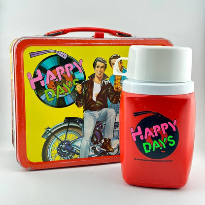 Happy Days lunchbox with thermos with images of characters from show, photographed on light background. 