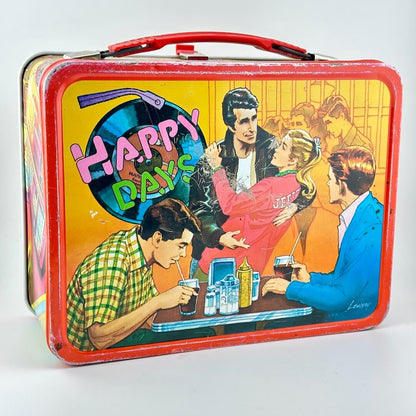 Happy Days lunchbox with images of characters from show on yellow background with red border. 