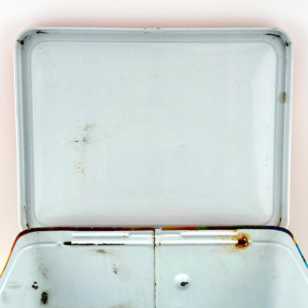 Interior lid view of metal lunchbox with a couple spots of wear. 