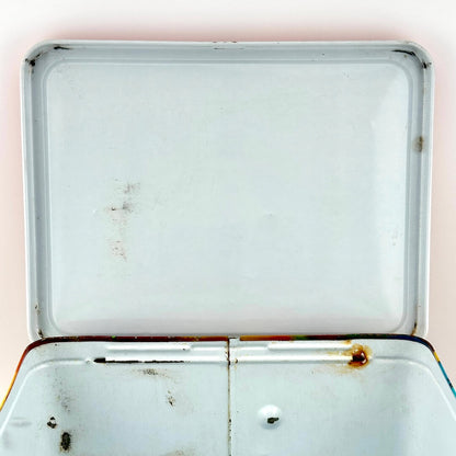 Interior lid view of metal lunchbox with a couple spots of wear. 