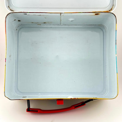 View of interior of metal lunchbox with some spots of rust but mostly white interior. 