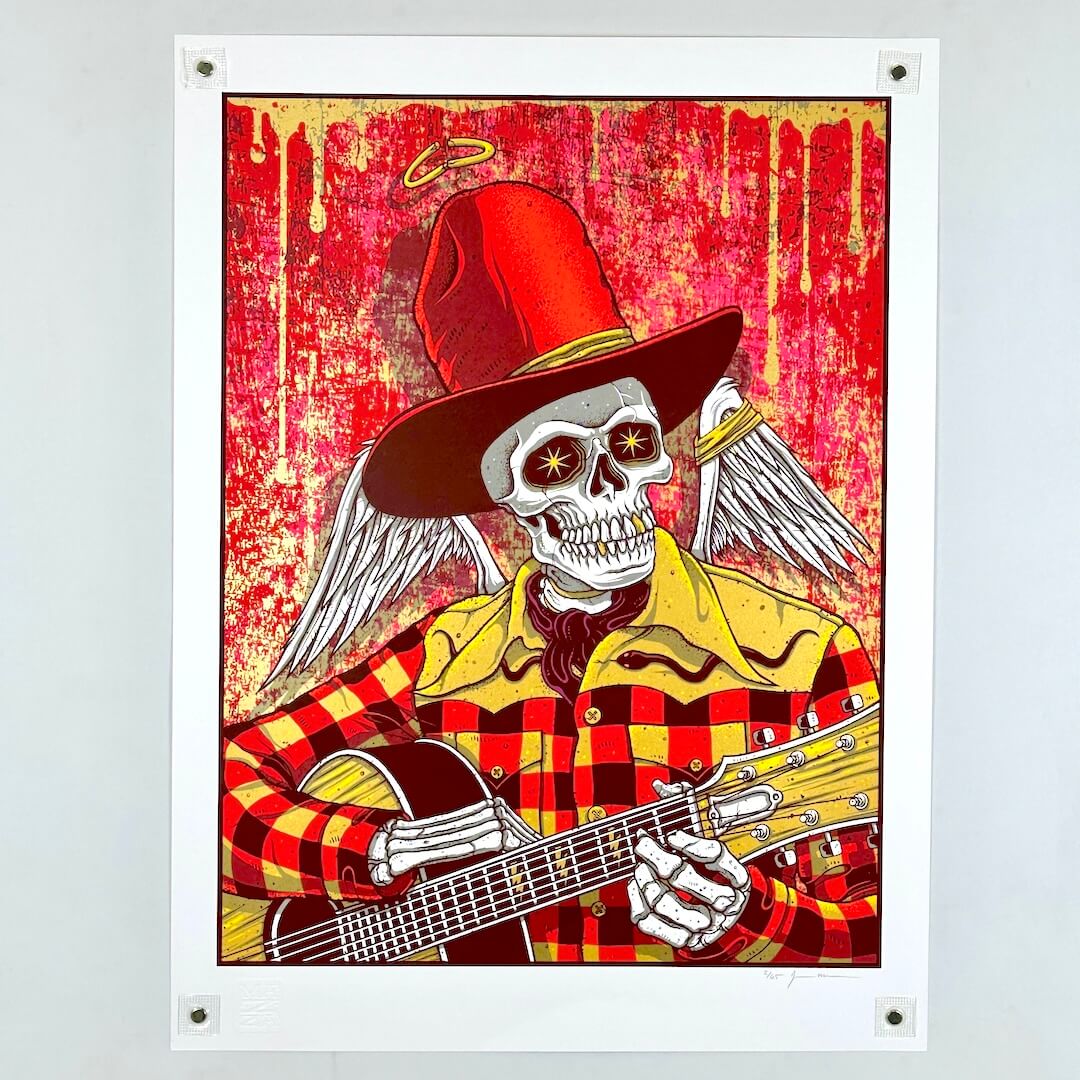 Poster of a skeleton in a red hat and plaid shirt playing an acoustic guitar against a red background.