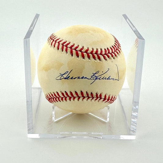 Signed baseball in clear display against white background.