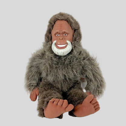 Stuffed animal resembling a humanoid figure with fur and a white beard on a white background