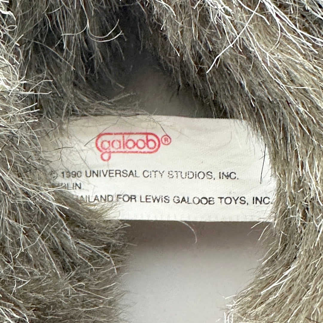 Close-up of a toy label inside a textured object, with 'Galoob' branding visible.