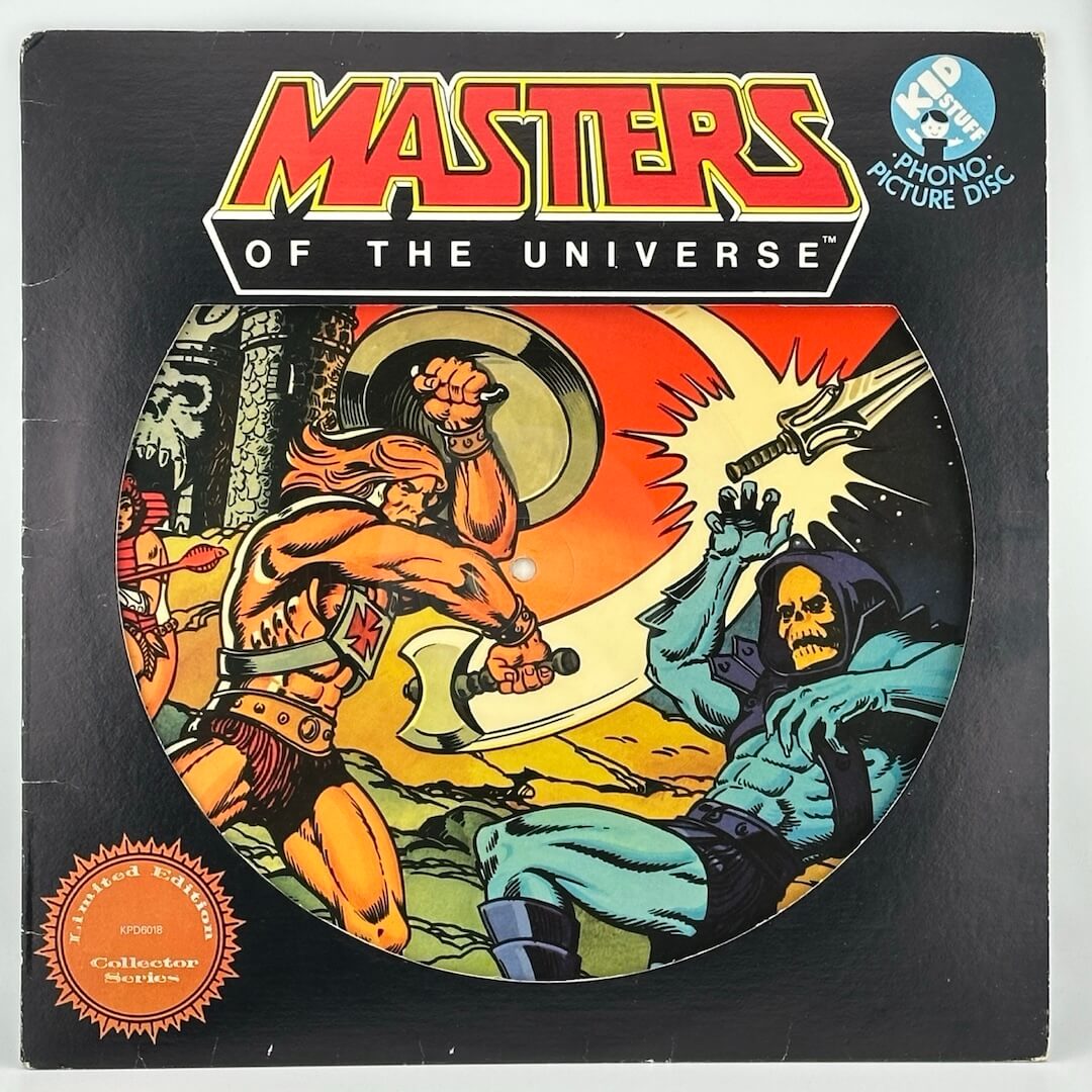 Black record sleeve with MOTU title logo top center, window shows picture disc featuring battle of Skeletor & He-Man. 