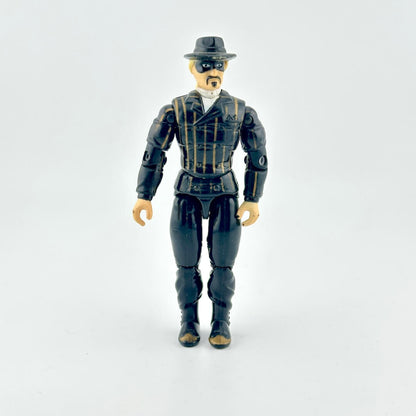 GI Joe action figure in black suit with gold pinstripes, wearing black hat and mask, photographed on white background. 
