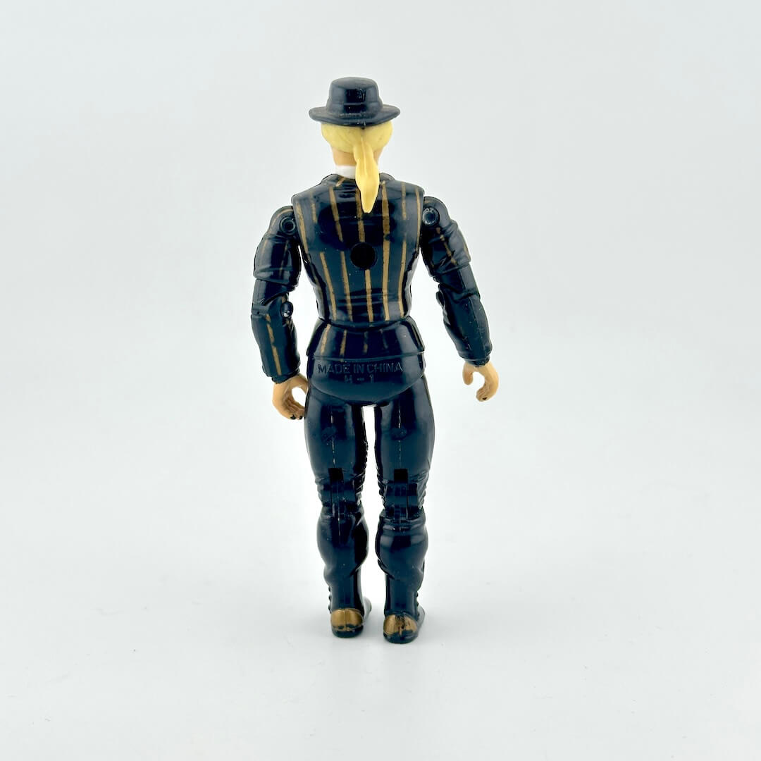 GI Joe action figure in black suit with gold pinstripes, wearing black hat and mask, photographed on white background.
