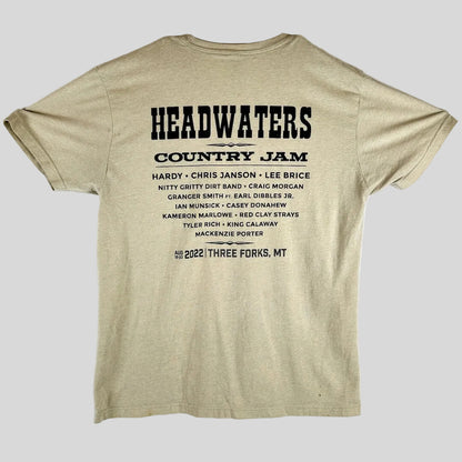 A beige t-shirt back with black text that reads 'HEADWATERS COUNTRY JAM' & a list of performing artists & the date/location.