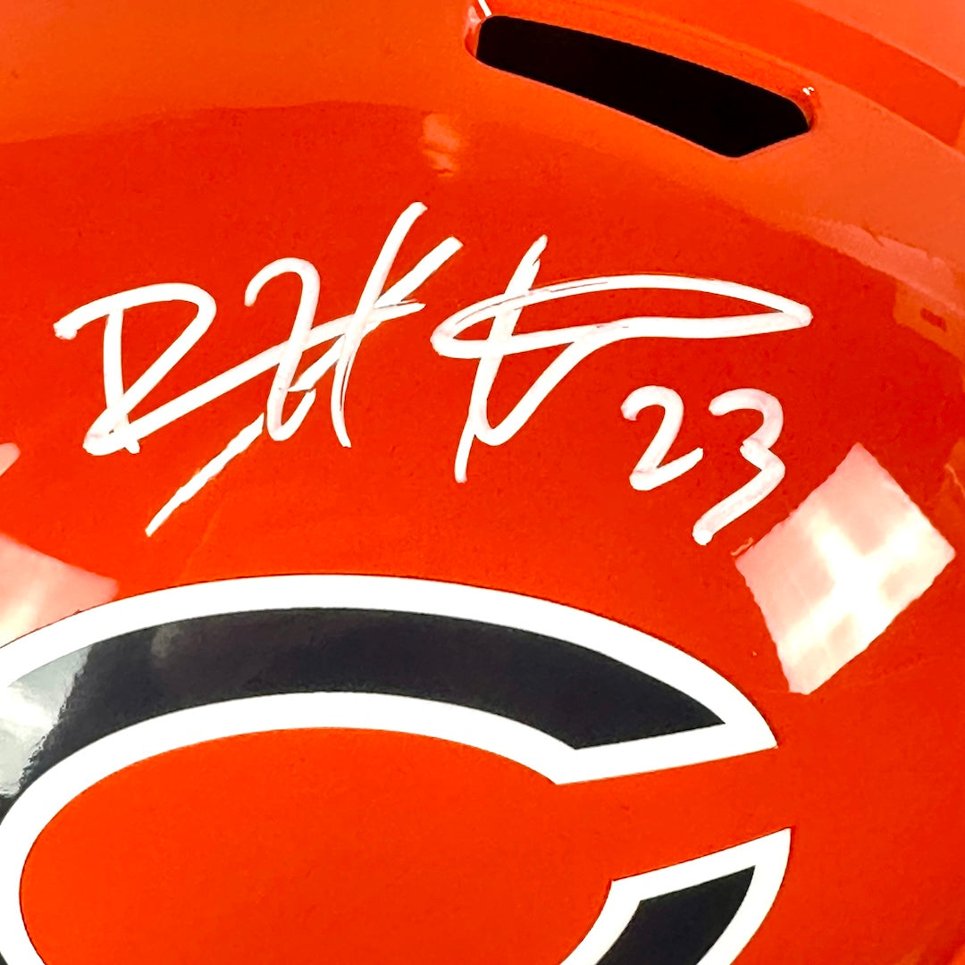 Close-up of an orange helmet with a signature and number '23' on it.
