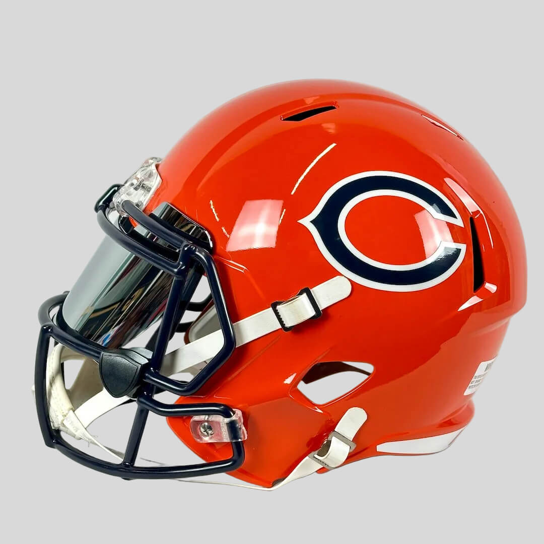 Orange football helmet with a logo on a white background