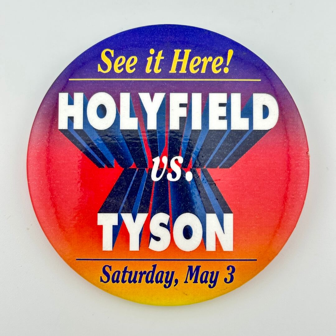 Pin with color gradient in background and "Holyfield vs. Tyson" as main text. 