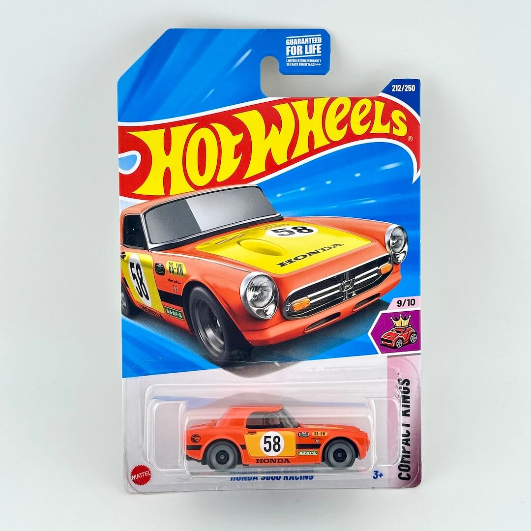 A Hot Wheels diecast toy car of an orange Honda S800, shown in its original blister pack packaging.