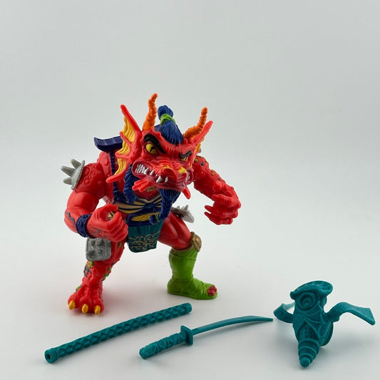 Anthropomorphized dragon wearing blue & silver samurai armor, one green boot, teal accessories.