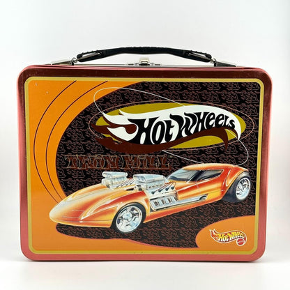 A vintage Hot Wheels metal lunch box with a red border, orange and brown graphic background.