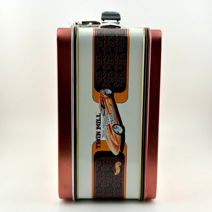 A rectangular metal lunch box with a red side border and a central white panel featuring a printed race car.