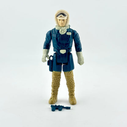 A vintage plastic action figure of a sci-fi character in a dark blue winter jacket, tan boots, and a beige hood.
