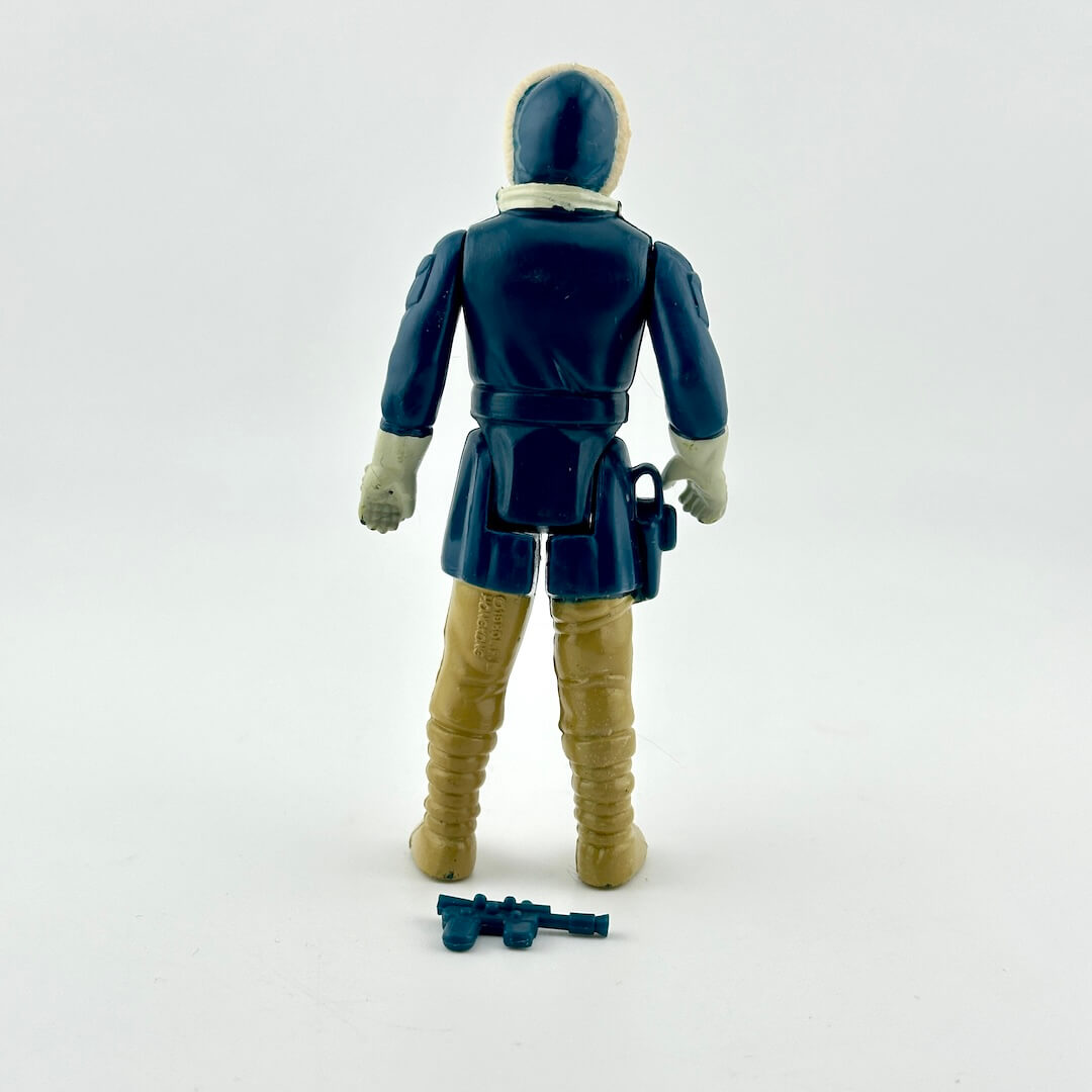 A vintage action figure shown from the back, wearing a dark blue coat, tan boots, and light gray gloves.
