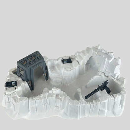 Model of a snowscape military base with buildings and guns on a plain background