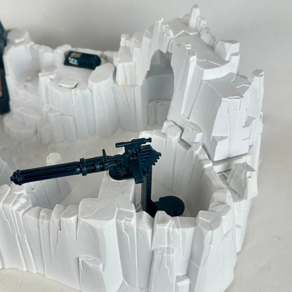 Model of a snowscape military base with buildings and guns on a plain background