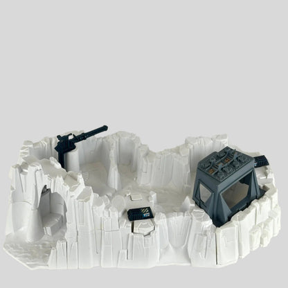Model of a snowscape military base with buildings and guns on a plain background
