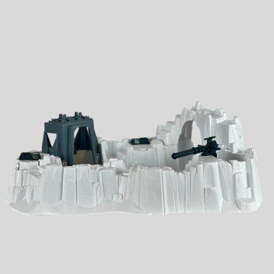 Model of a snowscape military base with buildings and guns on a plain background
