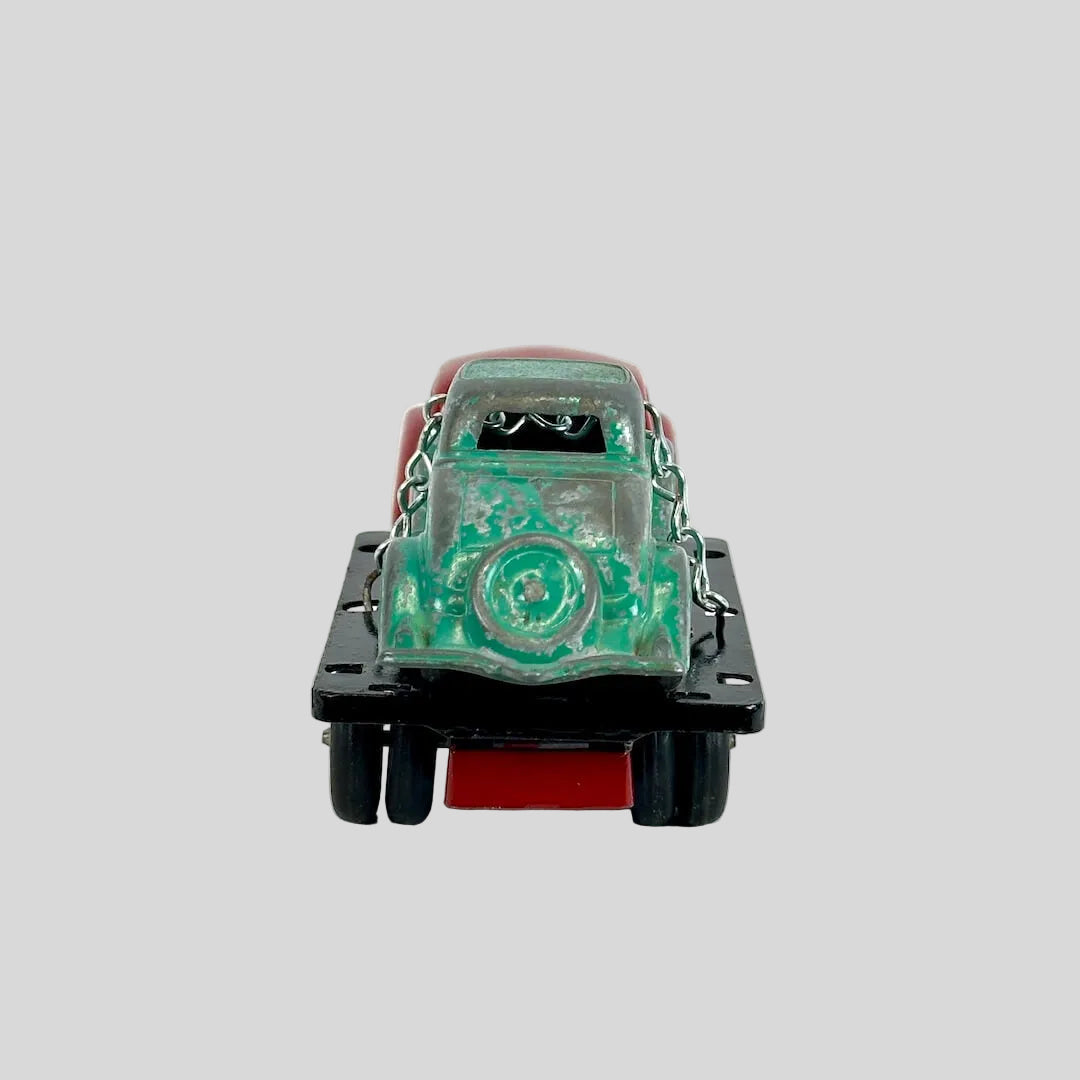 Toy car with a green and red design on a white background
