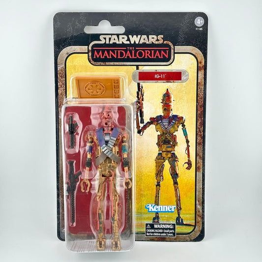 Star Wars The Mandalorian IG-11 action figure in its original blister card packaging, featuring the gold and red droid figure.