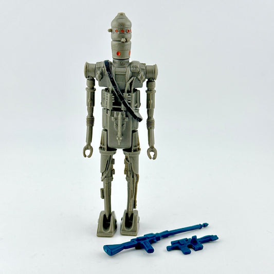 Toy figure of robot with two blue weapons on white background. 