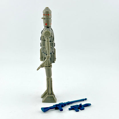 Toy robot figure with two blue weapons on a white background