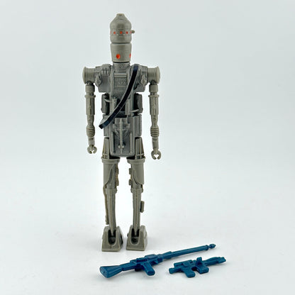 Toy robot figure with blue weapons on a white background.